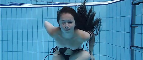Cute Umora is swimming nude in the pool